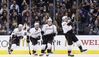 Anaheim Ducks left wing Patrick Maroon, right, celebrates his goal along with teammates, from left to right, Nick Bonino, Kyle Palmieri, and Ben Lovejoy, against the Los Angeles Kings during the second period of an NHL hockey game in Los Angeles, Saturday, March 15, 2014. (AP Photo/Danny Moloshok)