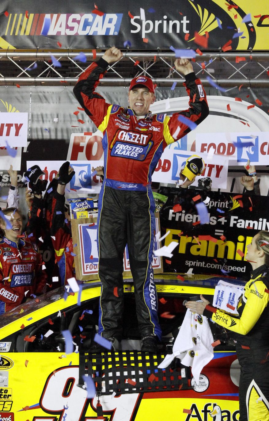 Driver Carl Edwards (99) celebrates in victory lane after winning the NASCAR Sprint Cup series auto race at Bristol Motor Speedway on Sunday, March 16, 2014, in Bristol, Tenn. (AP Photo/Wade Payne)