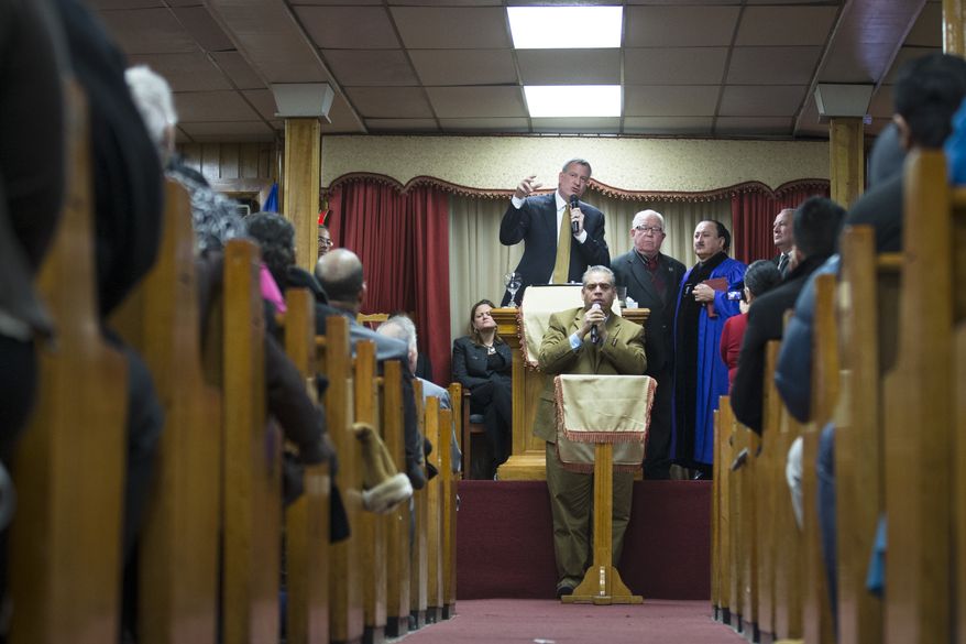 New York Mayor Bill de Blasio speaks as a translator assists below him during Sunday services at the Church of God of Third Avenue as the congregation welcomed members of the Spanish Christian Church that was destroyed by Wednesday&#39;s explosion in the East Harlem neighborhood of New York, Sunday, March 16, 2014. The Spanish Christian Church had been located on the first floor of one of the destroyed buildings. On Saturday a crew at the blast site found a large Bible in the rubble and returned it to the church&#39;s pastor. (AP Photo/John Minchillo)