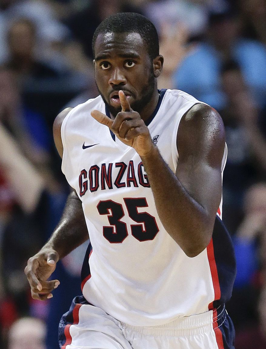 Gonzaga's Sam Dower Jr. gestures to teammate David Stockton after scoring on an assist by Stockton in the second half against BYU in an NCAA college basketball game for the West Coast Conference men's tournament title, Tuesday, March 11, 2014, in Las Vegas. Gonzaga won 75-64. (AP Photo/Julie Jacobson)