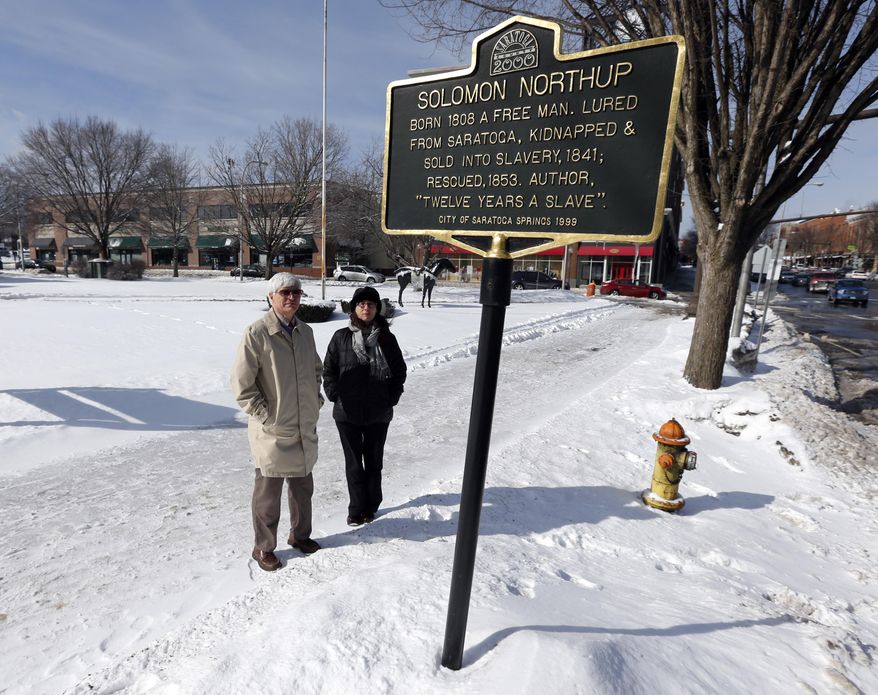 David Fiske, left, and Rachel Seligman, two of the co-authors of “Solomon Northup: The Complete Story of the Author of Twelve Years a Slave," pose at the Solomon Northup historical marker on Thursday, March 13, 2014, in Saratoga Springs, N.Y. (AP Photo/Mike Groll)