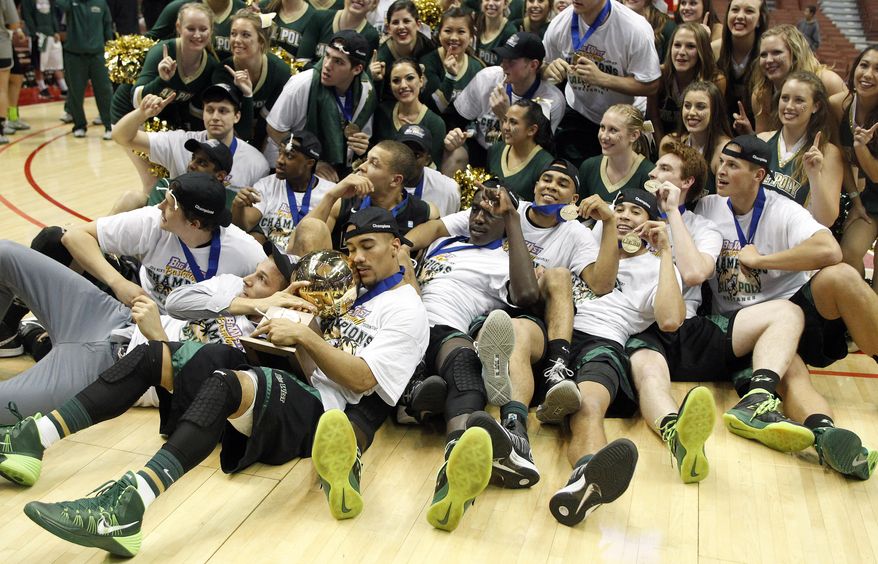 Cal Poly team poses with the trophy after defeating Cal State Northridge 61-59 in the NCAA Big West tournament championship college basketball game in Anaheim, Calif., Saturday, March 15, 2014. Cal Poly won 61-59. (AP Photo/Alex Gallardo)