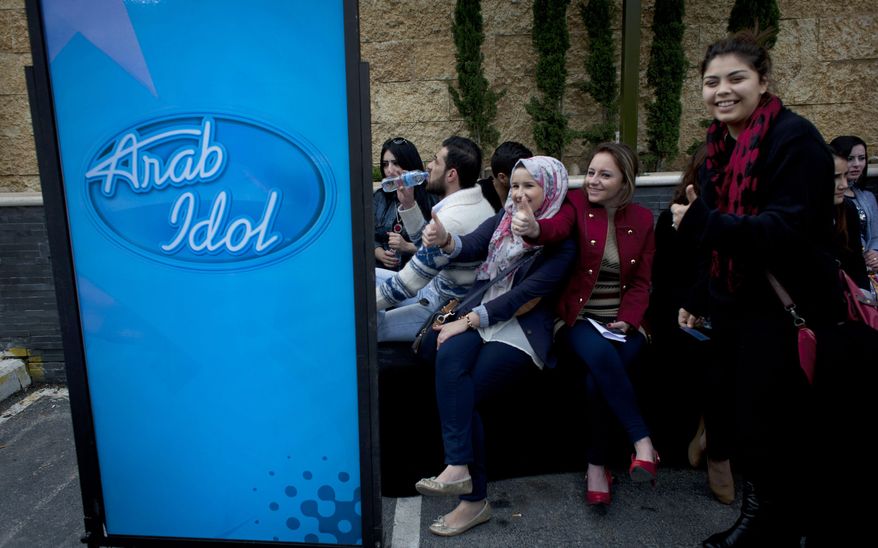 Palestinian youths wait for their turn to compete in the Arab world's premier talent show “Arab Idol,” at the luxury Grand Park Hotel, in the West Bank city of Ramallah, Monday, March 17, 2014. Hundreds of Palestinian youths lined up outside a luxury hotel at the crack of dawn on Monday for a chance to compete in the Arab world’s premier talent show, hoping to follow the unlikely example of last year’s winner and sing their way out of a life of conflict and poverty. (AP Photo/Nasser Nasser)