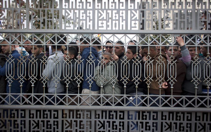 Hundreds of Palestinian youths line up waiting for a chance to compete in the Arab world's premier talent show “Arab Idol,” outside the luxury Grand Park Hotel, in the West Bank city of Ramallah, Monday, March 17, 2014. Hundreds of Palestinian youths lined up outside a luxury hotel at the crack of dawn on Monday for a chance to compete in the Arab world’s premier talent show, hoping to follow the unlikely example of last year’s winner and sing their way out of a life of conflict and poverty. (AP Photo/Nasser Nasser)