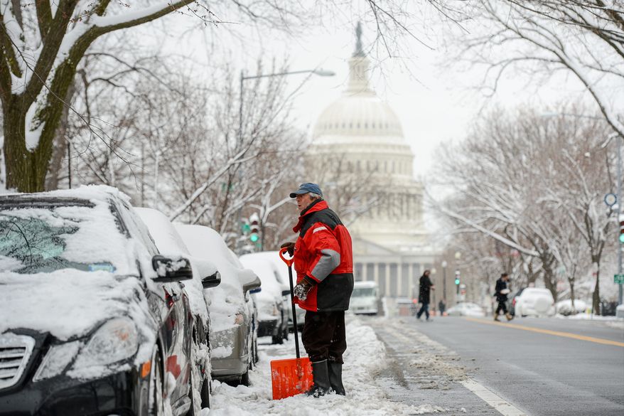 Steve Kreiss of Washington, D.C. shovels out his car Monday on East Capitol Street in Capitol Hill after another snowstorm hit the nation's capitol. (andrew harnik/the washington times)