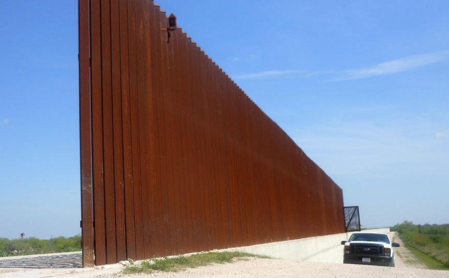 This photo made, Saturday, March 15, 2014 shows a border patrol vehicle patrolling along the Abram border fence in Abram, Texas., near where a migrant women, an adult who was traveling with her teenage daughter and a teenage friend, was spotted by a Border Patrol camera Wednesday afternoon. Officials said her wrists had been cut and were bloodied. She was one of three female immigrants from Honduras who according to officials tried to surrender to Border Patrol Agent Esteban Manzanares Wednesday afternoon near Anzalduas Park on Mission, Texas. Manzanares killed himself early Thursday and the FBI is investigating allegations that he kidnapped and assaulted the migrants before committing suicide. (AP Photo/Alicia A. Caldwell)
