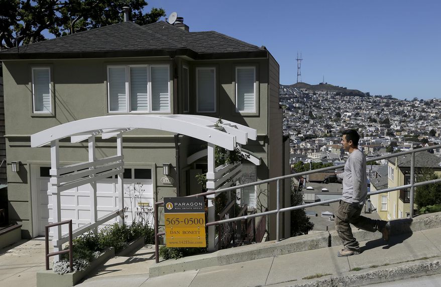 A man walks past a home for sale in San Francisco, Monday, March 17, 2014. San Francisco will now lend as much as $200,000 to some homebuyers toward a down payment on their first house or condominium. Mayor Ed Lee&#39;s decision to double the previous limit of $100,000 was intended to help middle-class residents who have been hit hard by the housing crunch. (AP Photo/Jeff Chiu)