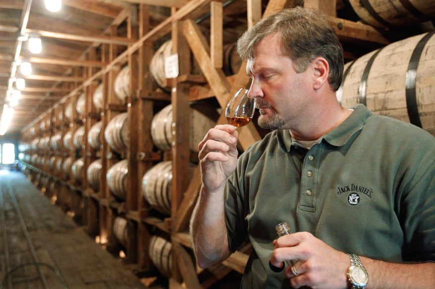 ** FILE ** In this May 20, 2009, file photo, Jeff Arnett, the master distiller at the Jack Daniel Distillery in Lynchburg, Tenn., tests the aroma of whiskey at the distillery. Jack Daniel's is fighting efforts in the state Legislature to dial back the legal definition of Tennessee whiskey, including a provision that requires the spirit to be aged in new oak barrels . (AP Photo/Mark Humphrey, File)