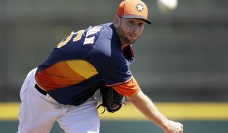 Houston Astros starting pitcher Scott Feldman warms up before a spring exhibition baseball game against the Washington Nationals in Kissimmee, Fla., Sunday, March 16, 2014. (AP Photo/Carlos Osorio)