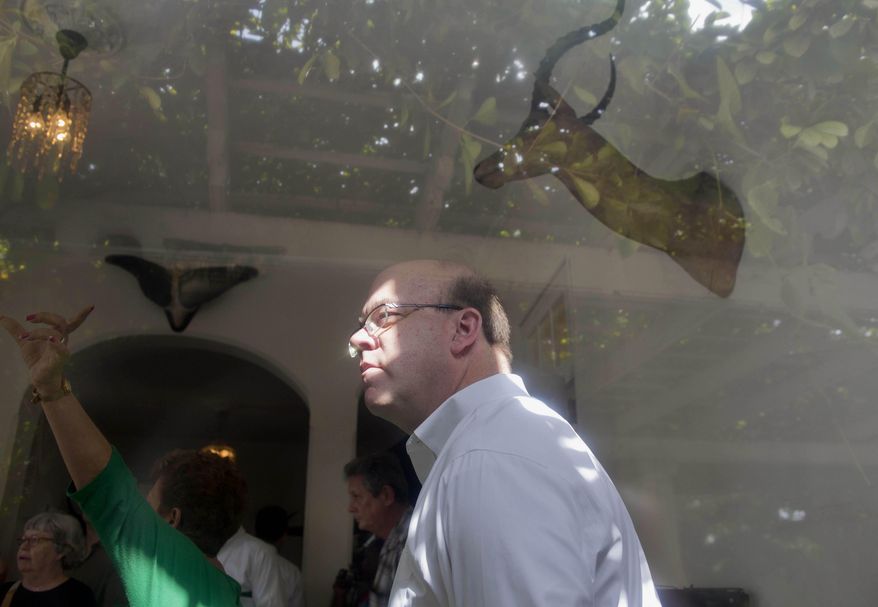 U.S. Congressman Jim McGovern listen's to an guided tour of Ernest Hemingway's former home near Havana, Cuba, Monday, March 17, 2014. Island curators gave the Massachusetts Democrat and a visiting U.S. delegation a rare guided tour inside the modest but graceful Finca Vigia, a hilltop estate that is surrounded by lush tropical fruit trees and boasts panoramic views of the Havana skyline. Scholars from both countries have been working together for more than a decade to preserve the home and its treasure trove of documents, everything from bar bills and bullfighting tickets to personal notes and recipes. (AP Photo/Ramon Espinosa)