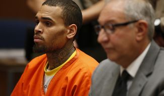 R&amp;B singer Chris Brown, left, appears in Los Angeles Superior Court with his attorney Mark Geragos, on Monday, March 17, 2014. Brown will spend another month in jail after a judge said Monday he was told the singer made troubling comments in rehab about being good at using guns and knives. The singer was arrested on Friday, March 14, 2014, after he was dismissed from a Malibu facility where he was receiving treatment for anger management, substance abuse and issues related to bipolar disorder. (AP Photo/Lucy Nicholson, Pool)