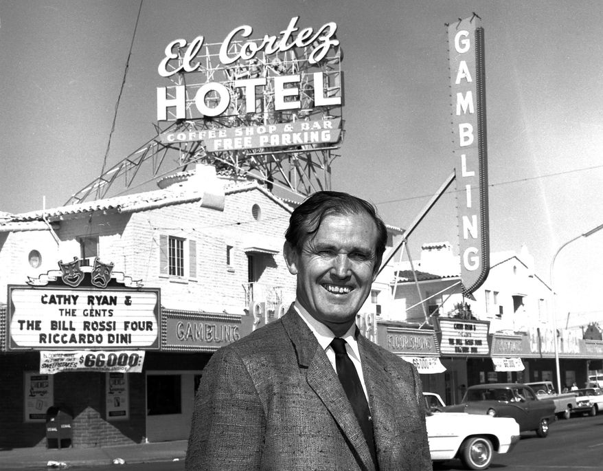 FILE - In this April 22, 1965 file photo provided by the Las Vegas News Bureau, casino owner Jackie Gaughan poses in front of his El Cortez Hotel and Casino in downtown Las Vegas. Gaughan, the Las Vegas gambling pioneer who once owned much of the downtown casino market, died Wednesday, March 12, 2014. He was 93. Gaughan is most closely associated with the El Cortez casino, which he bought in 1963. He later transferred ownership of the historic casino, but lived in a penthouse apartment there into his 90s and was known to play poker in the casino almost every day. (AP Photo/Las Vegas News Bureau, File)