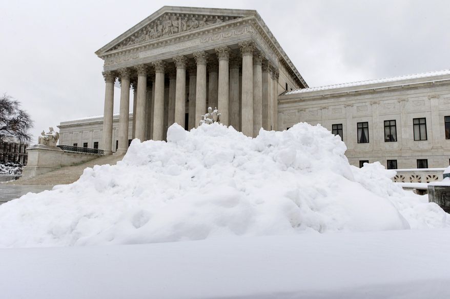 Shoveled snow is piled up at the Supreme Court in Washington, Monday, March 17, 2014, after a St. Patrick's Day snowstorm shut down the federal government and schools. With a harsh winter that closed the federal government, schools and offices for several days this year, Washington and other parts of the U.S. seemed to be getting used to digging out of the snow and cold as yet another storm blew into Mid-Atlantic and up the East Coast on Monday. (AP Photo/J. Scott Applewhite)
