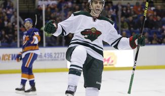 Minnesota Wild&#39;s Matt Moulson celebrates after scoring during the first period of the NHL hockey game against the New York Islanders, Tuesday, March 18, 2014, in Uniondale, New York. (AP Photo/Seth Wenig)