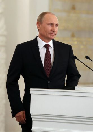 Russian President Vladimir Putin addresses the Federal Assembly in the Kremlin in Moscow on March 18, 2014. Putin signed a treaty to incorporate Crimea into Russia, describing the move as the restoration of historic injustice and a necessary response to what he called the Western encroachment on Russia’s vital interests. (Associated Press)