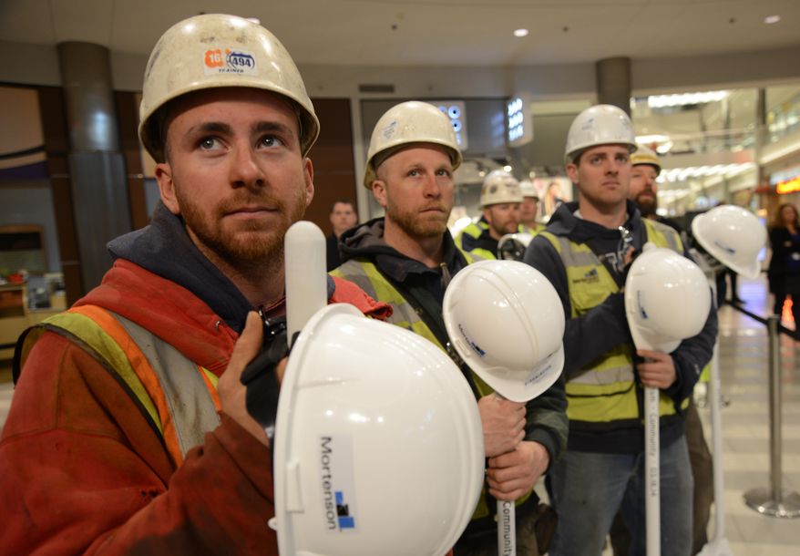 Construction workers look on during the groundbreaking ceremony for Mall of America's phase II, which will include a hotel, offices and more retail space, Tuesday, March 18, 2014, at the MOA Rotunda in Bloomington, Minn. Over 1000 new construction jobs are expected to be generated from project. (AP Photo/The Star Tribune, Richard Sennott) MANDATORY CREDIT; ST. PAUL PIONEER PRESS OUT; MAGS OUT; TWIN CITIES TV OUT