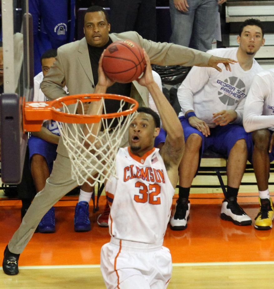 Georgia State head coach Ron Hunter, top center, watches as Clemson's K.J. McDaniels dunks in the first half of their NCAA college basketball National Invitational Tournament game at Littlejohn Coliseum in Clemson, S.C. on Tuesday March 18, 2014. (AP Photo/Anderson Independent-Mail, Mark Crammer) GREENVILLE NEWS - OUT; SENECA JOURNAL - OUT