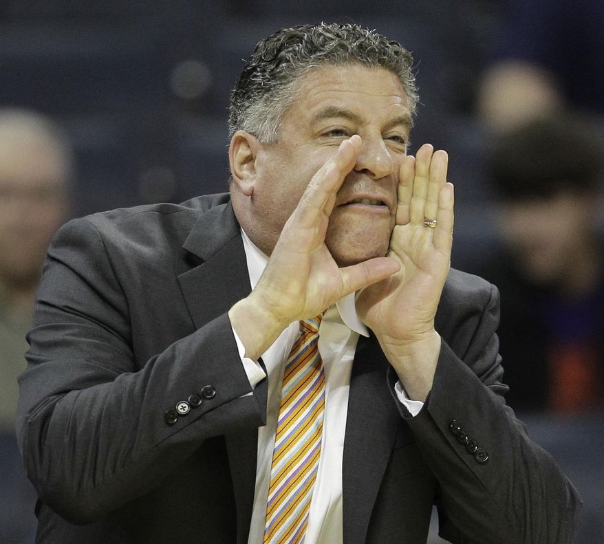 FILE - In this March 18, 2011 file photo, Tennessee head coach Bruce Pearl speaks to players in the first half of a West Regional NCAA tournament second round college basketball game against Michigan, in Charlotte, N.C. Auburn has hired former Tennessee coach Pearl to lead a struggling basketball program. The school announced the hiring on Tuesday, March 18, 2014, of the charismatic coach, who remains under a show-cause penalty from the NCAA. (AP Photo/File)