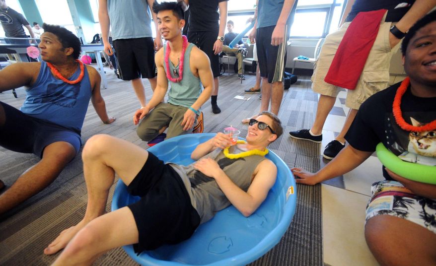 In this Tuesday, March 18, 2014 photo, students at Northampton Community College gather in the student lounge wearing summer clothing to participate in mock beach activities at the Bethlehem, Pa. school. The students are protesting the cancellation of spring break by wearing flip-flops, bathing suits and tank tops to class. (AP Photo/The Express-Times, Sue Beyer)