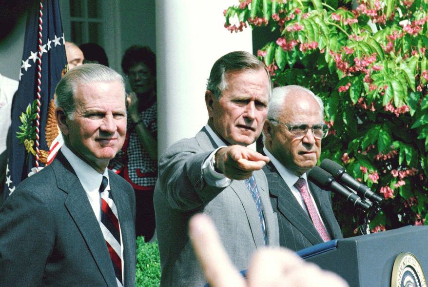 FILE - In this Aug. 20, 1991, file photo, President George H.W. Bush, flanked by  Secretary of State James Baker III, left, and U. S. Ambassador to the Soviet Union Robert Strauss, points to reporter during a Rose Garden press conference at the White House in Washington. Strauss, a former chairman of the Democratic Party and an ambassador to the Soviet Union, has died. Strauss' law firm confirmed his death Wednesday, March 19, 2014, at age 95. (AP Photo/Greg Gibson, File)