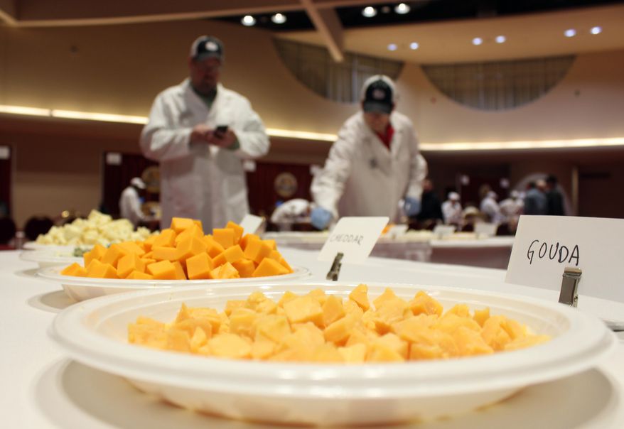 Free samples of cheese sit out for spectators during the first day of judging for 2014 World Championship Cheese Contest Tuesday, March 18, 2014, in Madison, Wis. Entries in the contest reached a new record this year, growing five percent to more than 2,600 entries from 22 nations around the world. (AP Photo/Carrie Antlfinger)