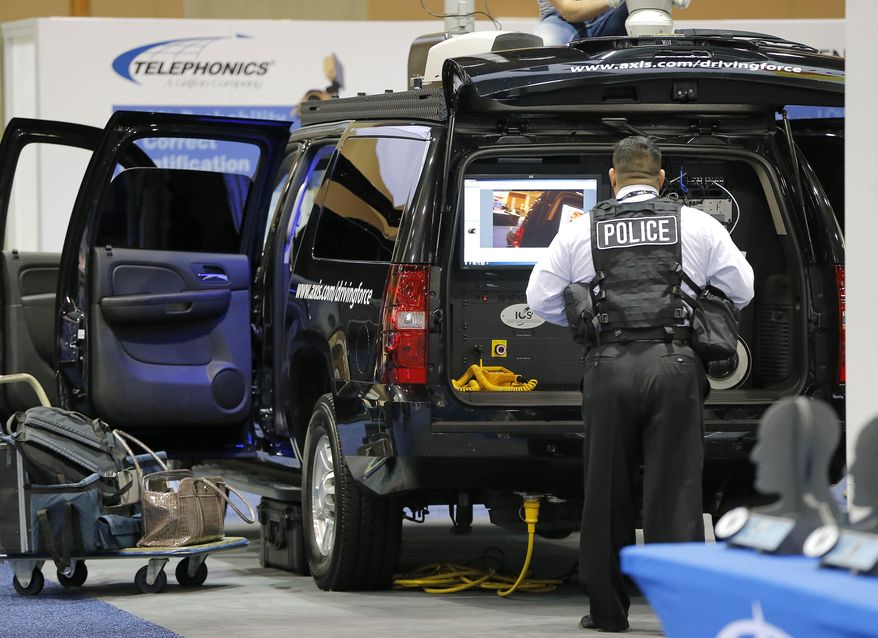 Exhibitors display products at the 8th annual Border Security Expo, Tuesday, March 18, 2014, in Phoenix. The two day event features panel discussions, sharing intelligence, and exhibitors displaying high-tech wares aimed at securing lucrative government contracts and private sales. (AP Photo/Matt York)