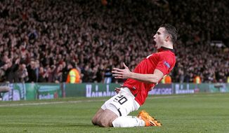 Manchester United&#x27;s Robin van Persie celebrates scoring his side&#x27;s third goal  and his hat-trick, during the Champions League, Round of 16, second leg match against Olympiakos,  at Old Trafford, Manchester,  England, Wednesday March 19, 2014. (AP Photo /PA, Peter Byrne) UNITED KINGDOM OUT