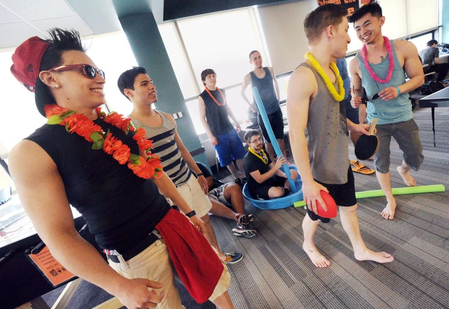 In this Tuesday, March 18, 2014 photo, students at Northampton Community College gather in the student lounge wearing summer clothing to participate in mock beach activities at the Bethlehem, Pa. school. The students are protesting the cancellation of spring break by wearing flip-flops, bathing suits and tank tops to class. (AP Photo/The Express-Times, Sue Beyer)