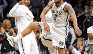 Brooklyn Nets&#39; Deron Williams (8) celebrates with teammates as he comes back to the bench during the fourth quarter of an NBA basketball game against the Charlotte Bobcats Wednesday, March 19, 2014, at Barclay&#39;s Center in New York. Brooklyn won 104-99. (AP Photo/Bill Kostroun)
