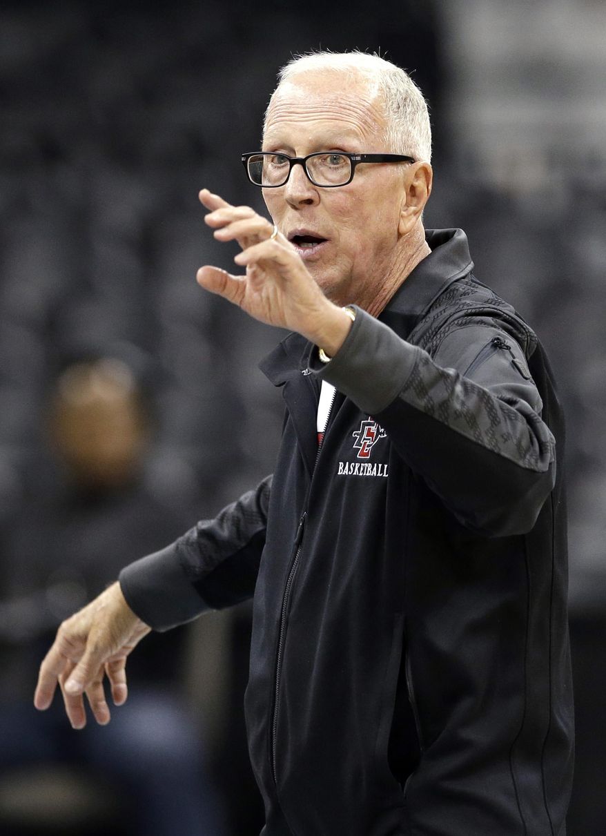 San Diego State head coach Steve Fisher directs his team during practice for the NCAA college basketball tournament in Spokane, Wash., Wednesday, March 19, 2014. San Diego State plays against New Mexico State in a second-round game on Thursday. (AP Photo/Elaine Thompson)