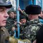 Ukrainian servicemen struggle to defend the navy headquarters in Crimea. Story, A10. (Associated Press)