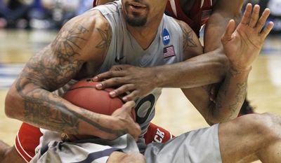 Xavier forward Justin Martin, front, keeps a loose ball away from North Carolina State forward T.J. Warren during the second half of a first-round game of the NCAA college basketball tournament, Tuesday, March 18, 2014, in Dayton, Ohio. (AP Photo/Skip Peterson)