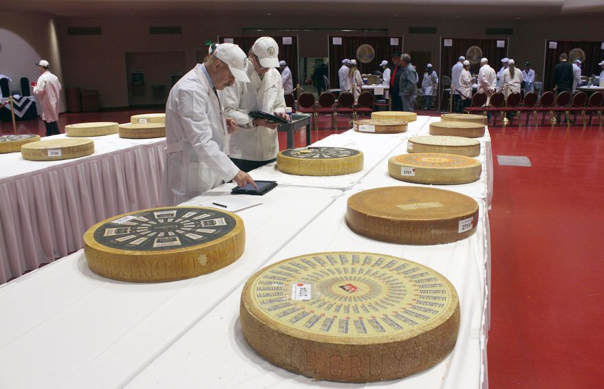 Judges enter their findings into iPads during the first day of the 2014 World Championship Cheese Contest, Tuesday, March 18, 2014, in Madison, Wis. Entries in the 2014 World Championship Cheese Contest reached a new record this year, growing five percent to more than 2,600 entries from 22 nations around the world. (AP Photo/Carrie Antlfinger)