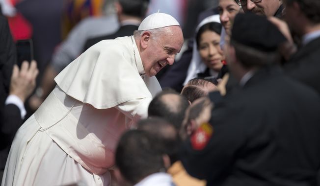 Pope Francis blesses sick people as he leaves St.Peter&#x27;s Square, at the Vatican at the end of his weekly general audience, Wednesday, March 19, 2014. (AP Photo/Andrew Medichini)