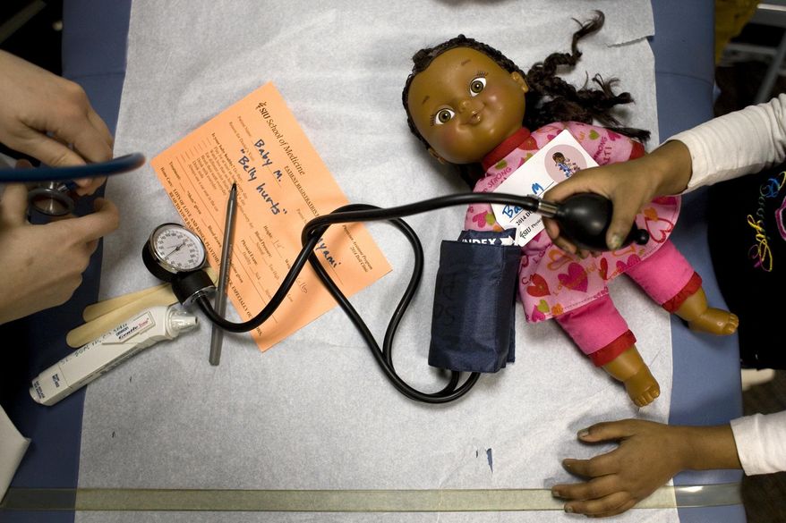 ADVANCE FOR USE SATURDAY, MARCH 22 AND THEREAFTER - In this March 6, 2014 photo, "Baby M" is examined during the doll clinic hosted by the Southern Illinois University School of Medicine at the campus in Carbondale, Ill. The doll clinic gives children the opportunity to observe scary or threatening medical procedures, without being the subject of those procedures. (AP Photo/The Southern, Steve Matzker)