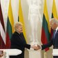 Vice President Joe Biden, right, shakes hands with  Lithuania&#39;s President Dalia Grybauskaite after giving a joint statement at the Presidential palace in Vilnius, Lithuania, Wednesday, March 19, 2014. Vice President Joe Biden has arrived in Lithuania to reassure Baltic leaders that the U.S. is committed to defending its NATO allies in the face of Russia&#39;s intervention in Crimea. (AP Photo/Mindaugas Kulbis)