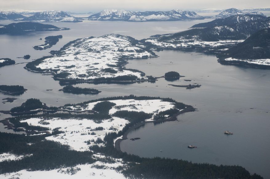 FILE - In this Dec. 24, 2009 file photo, the tug Pathfinder is surrounded by a spill containment boom, in Prince William Sound, Alaska. It is the left of the two boats at the bottom right of photo. The Pathfinder, a 136-foot tug scouting for ice along Prince William Sound's oil shipping lanes near Valdez, Alaska, grounded on Bligh Reef. Something is holding down the herring population of Alaska's Prince William Sound. Marine scientists are tailing a possible suspect: humpback whales. Humpbacks are thriving in the waters fouled 21 years ago by the Exxon Valdez oil spill. At the time, the herring population crashed, but should have rebounded by now. Nearly 25 years after the Exxon Valdez oil spill off the coast of Alaska, some damage heals, some effects linger in Prince William Sound. (AP Photo/Anchorage Daily News, Marc Lester, File) FRONTIERSMAN OUT