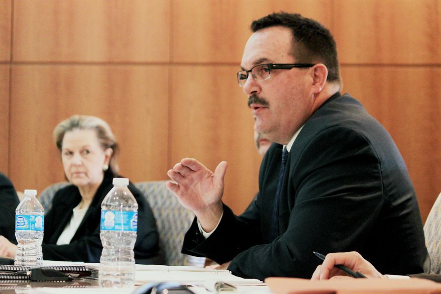 Colorado Commissioner Dick Wolfe, right, asks a question during the Rio Grande Compact Commission's annual meeting in Santa Fe, N.M., Thursday, Mar. 20, 2014. Commissioners heard from federal experts about the challenges water managers will face due to the effects of drought on the Rio Grande. (AP Photo/Susan Montoya Bryan)