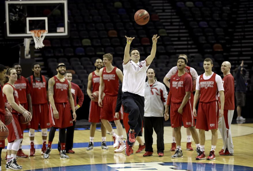 Nebraska coach Tim Miles shoots from half court as his team watches during practice for the NCAA college basketball tournament in San Antonio, Thursday, March 20, 2014. Nebraska plays against Baylor in a second-round game on Friday. (AP Photo/David J. Phillip)