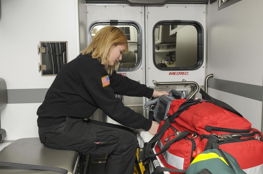 ADVANCE FOR SUNDAY, MARCH 23 - In this photo taken on March 13, 2014, Caylee Knafel, a senior at Churubusco High School, checks the monitor in a Huntertown Fire Department ambulance in Huntertown, Indiana. Knafel is part of an internship that helps to train volunteers for the department. (AP Photo/The Journal-Gazette, Michele Davies) NEWS-SENTINEL OUT; MANDATORY CREDIT; NO SALES; MAGS OUT
