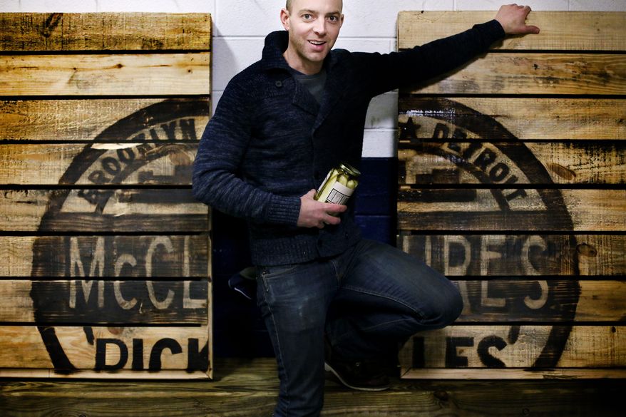 ADVANCE FOR MONDAY, MARCH 24 - In this photo taken on March 4, 2014, Joe McClure, co-owner of McClure's Pickles poses for a photograph at his warehouse in Detroit. (AP Photo/Detroit Free Press, Kimberly P. Mitchell) DETROIT NEWS OUT; NO SALES, TV OUT. MANDATORY CREDIT