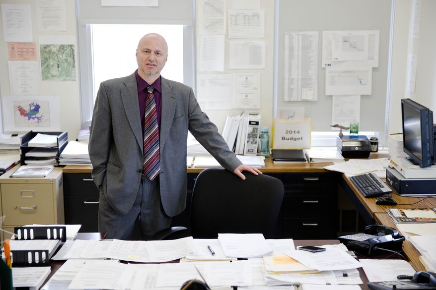 Public works director Mike Alkhal poses for a photograph Wednesday, March 19, 2014, in Bethlehem, Pa. Alkhal said the city will delay the downtown streetscape project that would replace slate and brick sidewalks, urns, benches and trees. The city has no choice after more than doubling its usual spending on winter maintenance, including a hefty overtime bill for road crews. (AP Photo/Matt Rourke)