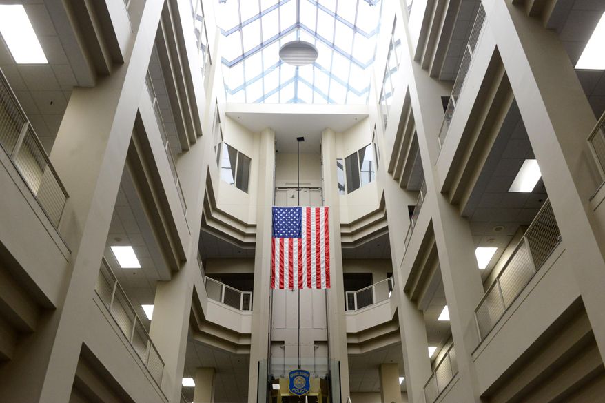 This March 11, 2014 photo shows The Grand Rapids police station lobby in Grand Rapids, Mich. Grand Rapids plans a $345,000 renovation to its police station lobby that will address long-held security concerns and restrict public access inside the department's headquarters. Capt. David Kiddle says that security at the Monroe Center headquarters was set before the Sept. 11, 2001 terrorist attacks. The facility opened before the attacks. It doesn't have a secure lobby and one entrance was shut to boost security. Under the new plans, officers would sit behind bullet-resistant glass. A staircase and elevator leading to offices wouldn't be accessible to the public. (AP Photo/The Grand Rapids Press, Emily Rose Bennett) ALL LOCAL TV OUT; LOCAL TV INTERNET OUT