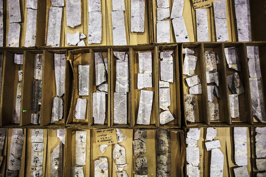 ADVANCE FOR RELEASE SUNDAY, MARCH 23, 2014, AT 12:01 A.M. EDT - In this Friday, Feb. 21, 2014 photo, sliced reef cores lie on tables inside Western Michigan University's Michigan Geological Repository, in Kalamazoo, Mich. The reef cores were extracted thousands of feet underground and are used to study how to flush out oil using carbon dioxide from the reefs. (AP Photo/Kalamazoo Gazette-MLive Media Group, Chuck Miller) ALL LOCAL TV OUT; LOCAL TV INTERNET OUT