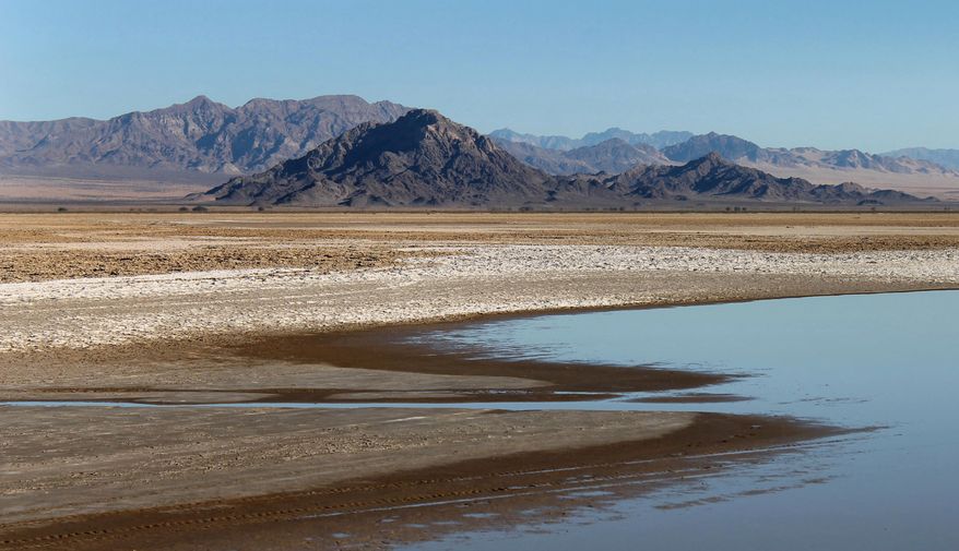 In this undated photo, the Soda Lake in the Mojave National Preserve reflects the sky in San Bernardio County, Calif. A commercial solar project is proposed within a mile of the lake bed, prompting worries about water depletion and the fate of an endangered fish, among other concerns. (AP Photo/The Press-Enterprise, David Danelski) MAGS OUT; MANDATORY CREDIT
