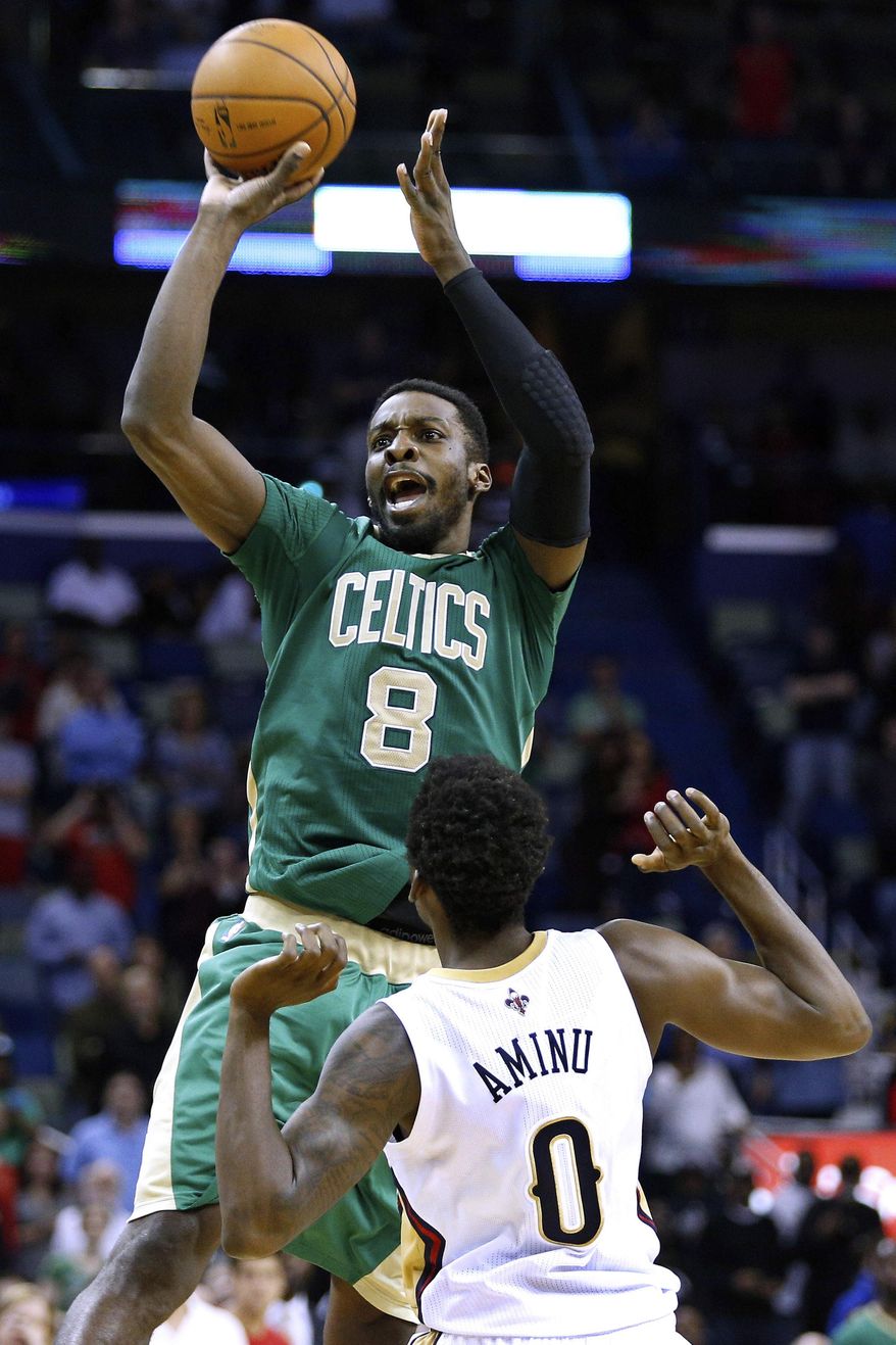 ADVANCE FOR WEEKEND EDITIONS, MARCH 22-23 - FILE - In this March 16, 2014, file photo, Boston Celtics forward Jeff Green (8) shoots over New Orleans Pelicans forward Al-Farouq Aminu (0) during the second half of an NBA basketball game in New Orleans. Green, Phoenix's Channing Frye, Timberwolves' Ronny Turiaf and Toronto's Chuck Hayes, all have recovered from serious heart conditions to continue their careers.  (AP Photo/Jonathan Bachman)