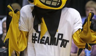 &amp;quot;Herky,&amp;quot; the Iowa mascot, wears a T-shirt supporting Pat McCaffery, son of Iowa head coach Fran McCaffery, at halftime of a first-round game against Tennessee in the NCAA college basketball tournament on Wednesday, March 19, 2014, in Dayton, Ohio. Coach McCaffery flew home to be with his 13-year-old son who had a tumor removed Wednesday morning and then flew back to Dayton for their game against Tennessee. (AP Photo/Al Behrman)
