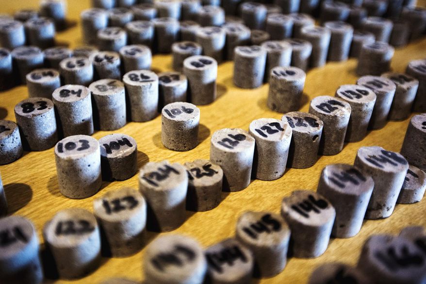 ADVANCE FOR RELEASE SUNDAY, MARCH 23, 2014, AT 12:01 A.M. EDT - In this Friday, Feb. 21, 2014 photo, tiny cylinders of reef cores lie on tables inside Western Michigan University's Michigan Geological Repository, in Kalamazoo, Mich. The reef cores are used to study how to flush out oil using carbon dioxide from the reefs. (AP Photo/Kalamazoo Gazette-MLive Media Group, Chuck Miller) ALL LOCAL TV OUT; LOCAL TV INTERNET OUT