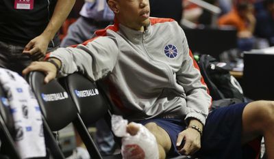 Arizona forward Brandon Ashley, sidelined with a broken foot, watches his team practice for an NCAA college basketball tournament game on Thursday, March 20, 2014, in San Diego. Arizona faces Weber State in a second-round game on Friday. AP Photo/Lenny Ignelzi)