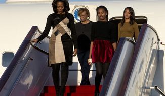 U.S. First Lady Michelle Obama, front left, her daughters Sasha, front right, Malia, right in the back, and Michelle Obama&#39;s mother Marian Robinson, left in the back, arrive at Capital International Airport in Beijing, China, Thursday, March 20, 2014. Michelle Obama has arrived in Beijing with her mother and daughters to kick off a seven-day, three-city tour where she will focus on education and cultural exchange. (AP Photo/Alexander F. Yuan, Pool)